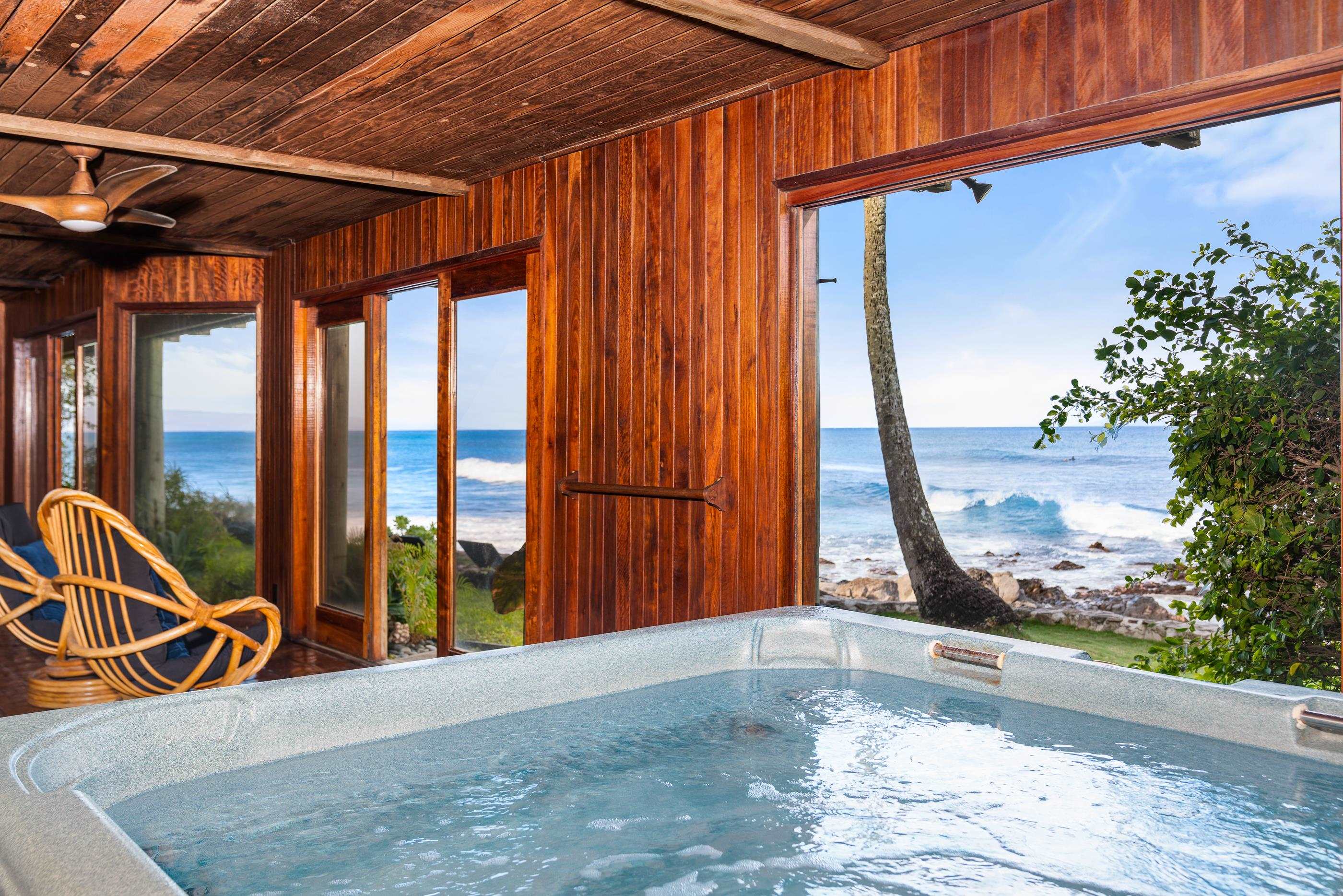 The large indoor hot tub beside its ocean-view windows